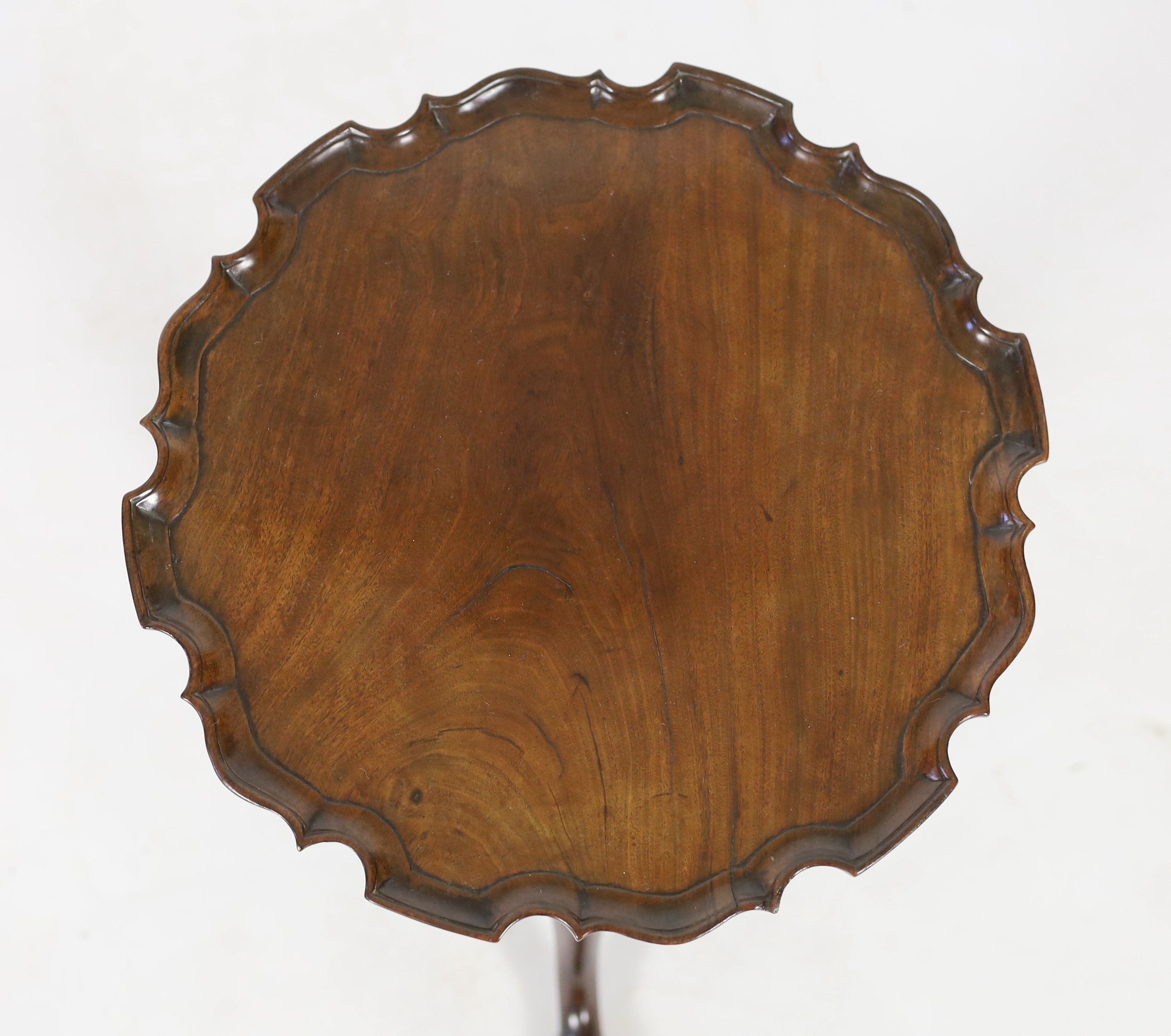A George III and later mahogany tripod wine table, with circular piecrust top and spiral fluted stem on cabriole tripod base with pointed pad feet, diameter 38cm height 52cm